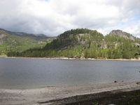 Utsikt frå bedehuset til Lønnegrav gravplass. Klokkestøpulen er synleg. (Foto: Olav Momrak-Haugan, 2011)