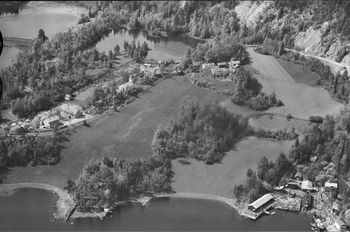 NORDRE NÆRSNES OG ISDAMMENE 1950 Nordre Nærsnes med jordene ned mot sjøen. Mellom de de to jordene til høyere ligger den lille Graffdammen. Øverst midt på bildet er Schwartzdammen, like ved hovedveien fra Morberg til Nærsnes. Øverst til venstre ser vi de to dammene kjent som Nydammene eller Bårsruddammene. Skolen (nå Nærsnes Grendehus) og Nærsnes kirke til venstre. Bukta midt på bildet er nå en del av småbåthavna i Grundvik. (Foto; Widerøe, Samling; Nasjonalbiblioteket)